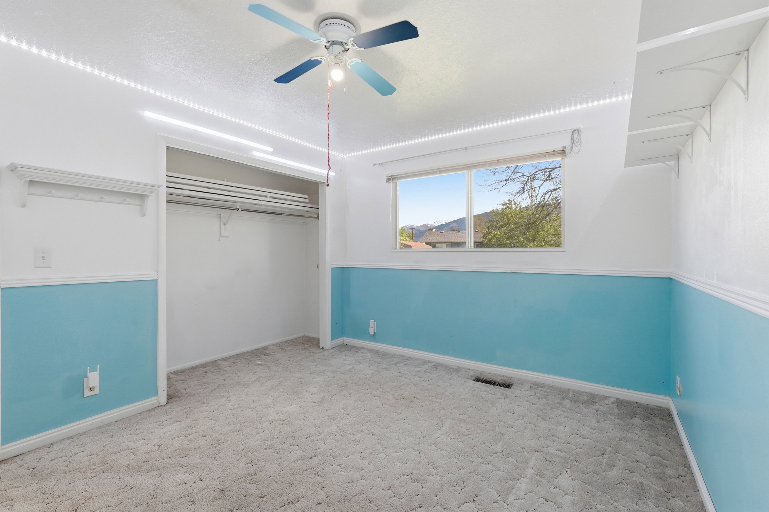 Unfurnished bedroom with carpet floors, a ceiling fan, and a closet