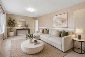 Living room featuring carpet flooring and baseboards