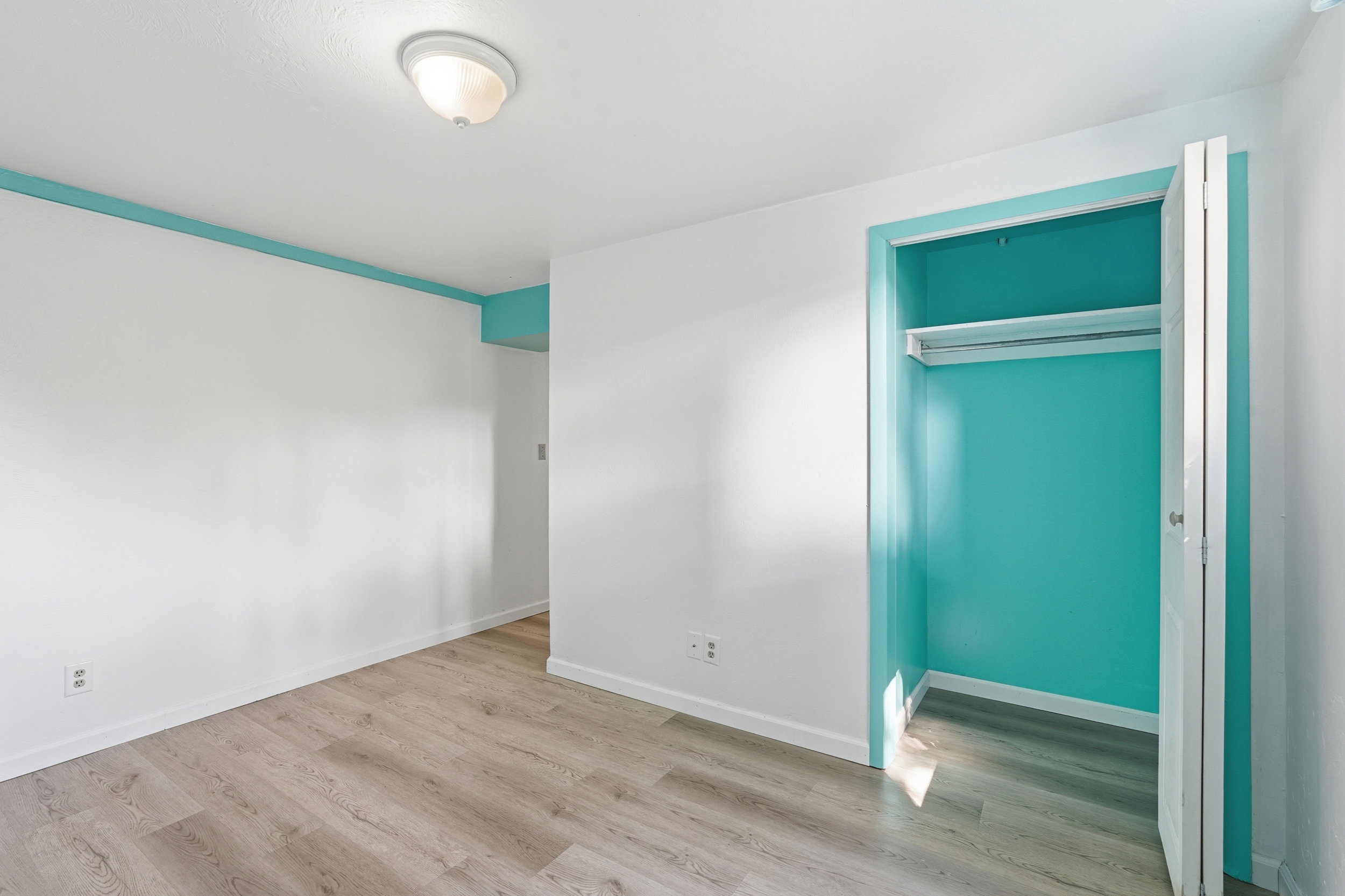 Unfurnished bedroom featuring light wood-type flooring and a closet