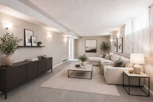 Living area featuring light carpet and a textured ceiling