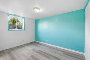 Unfurnished room featuring light wood-type flooring and baseboards