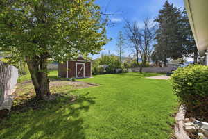 Fenced backyard with a shed