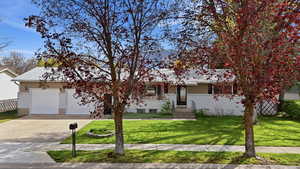 View of front of house with driveway and a garage