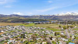 Aerial perspective of suburban area featuring a water and mountain view