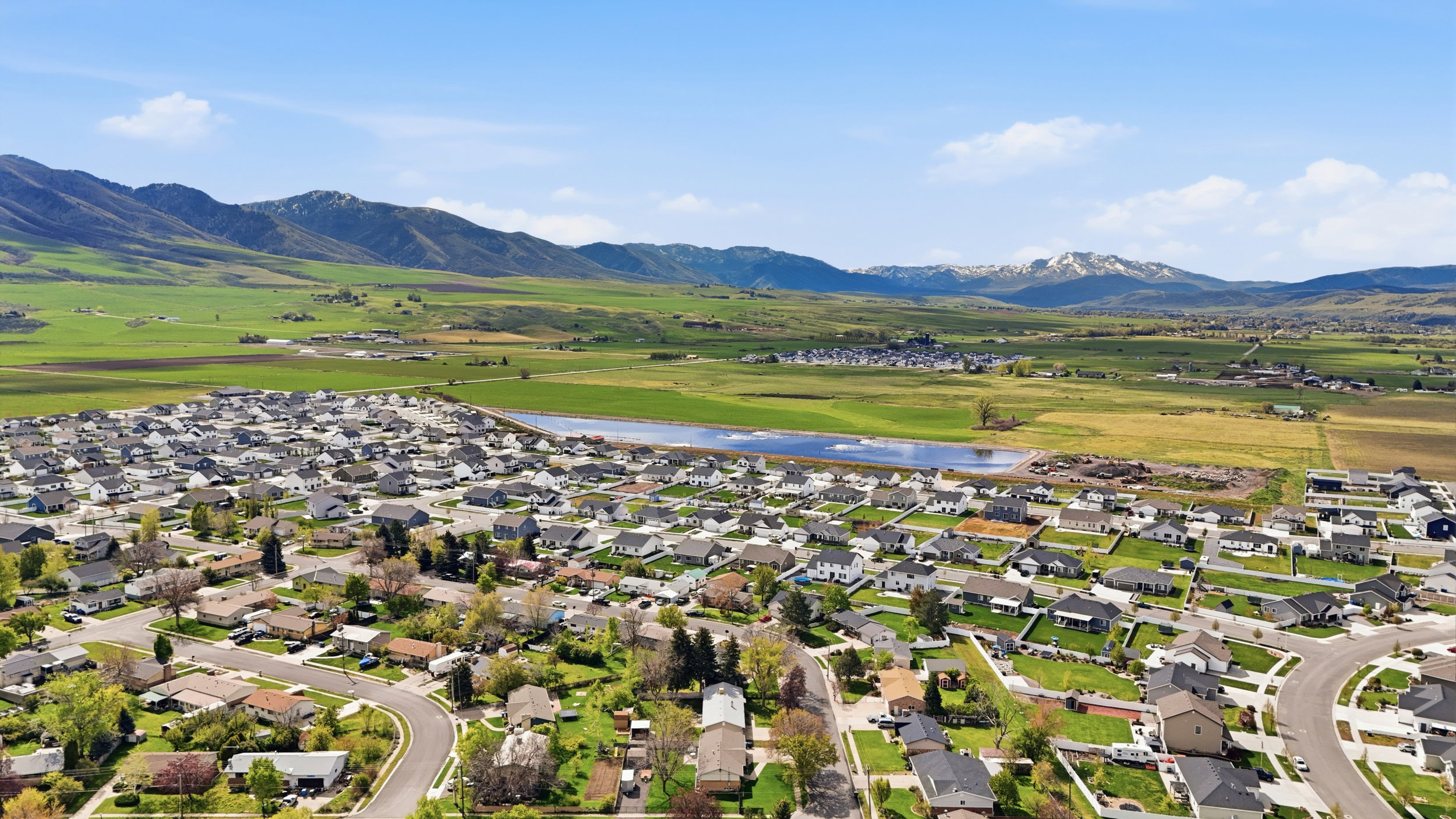 Aerial perspective of suburban area with a water and mountain view