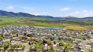 Aerial perspective of suburban area with a water and mountain view