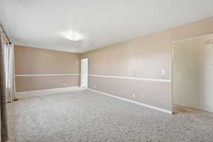 Unfurnished room featuring light carpet