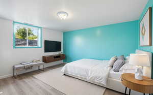 Bedroom featuring wood finished floors and baseboards