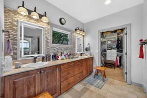 Double vanity featuring undermount sinks, light-toned countertops, and wood-finish cabinetry