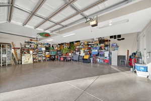 Spacious garage with an epoxy-coated concrete floor and multiple overhead garage doors