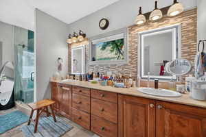 Double vanity with wood-finish cabinetry and light-toned countertops