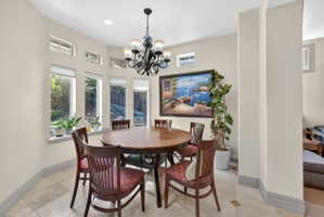 Dining room with suspended lighting and baseboards