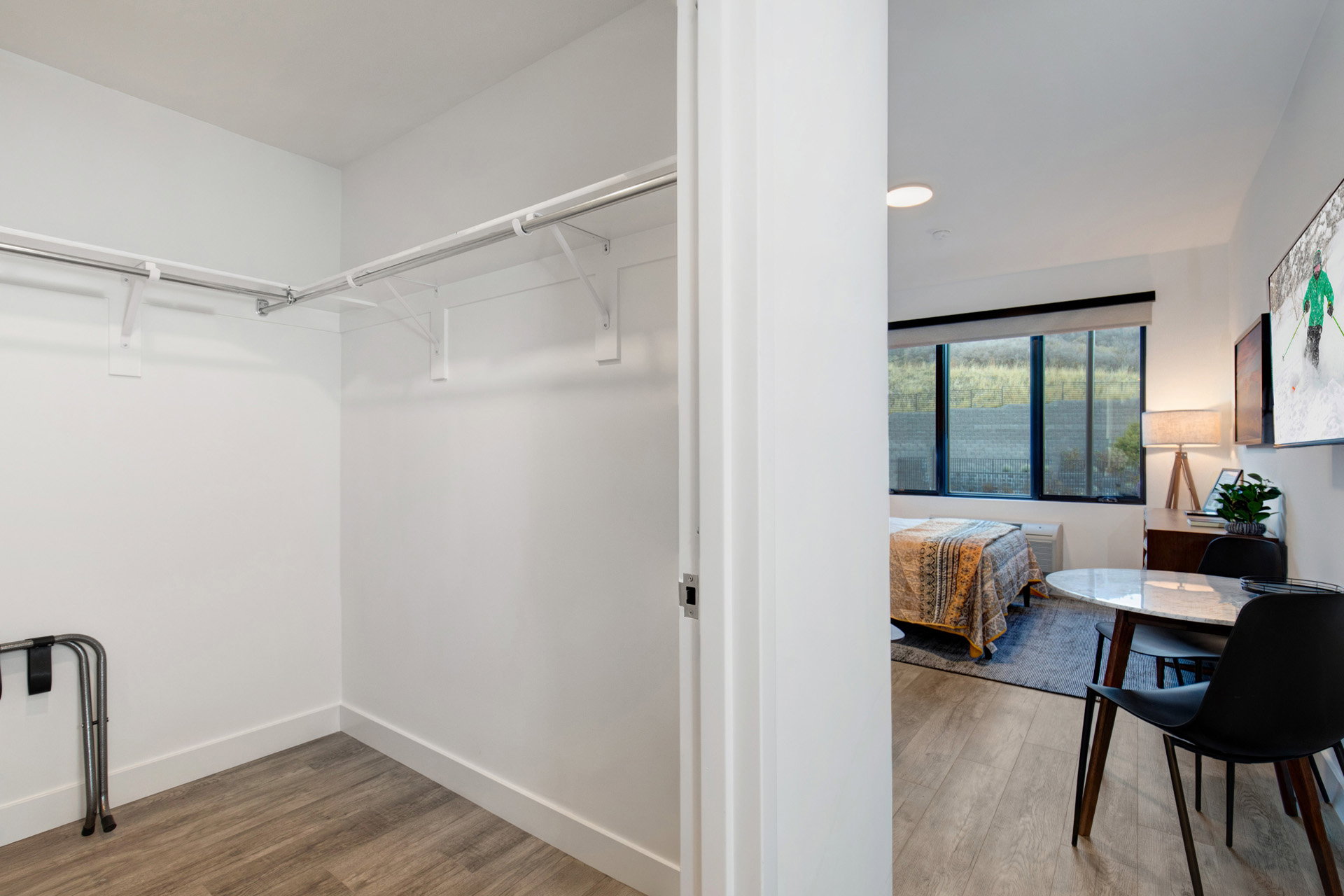 Walk in closet with light wood-type flooring