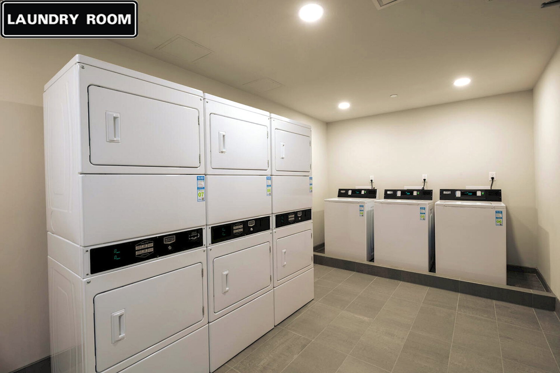 Shared laundry room with recessed lighting and stacked washer / drying machine