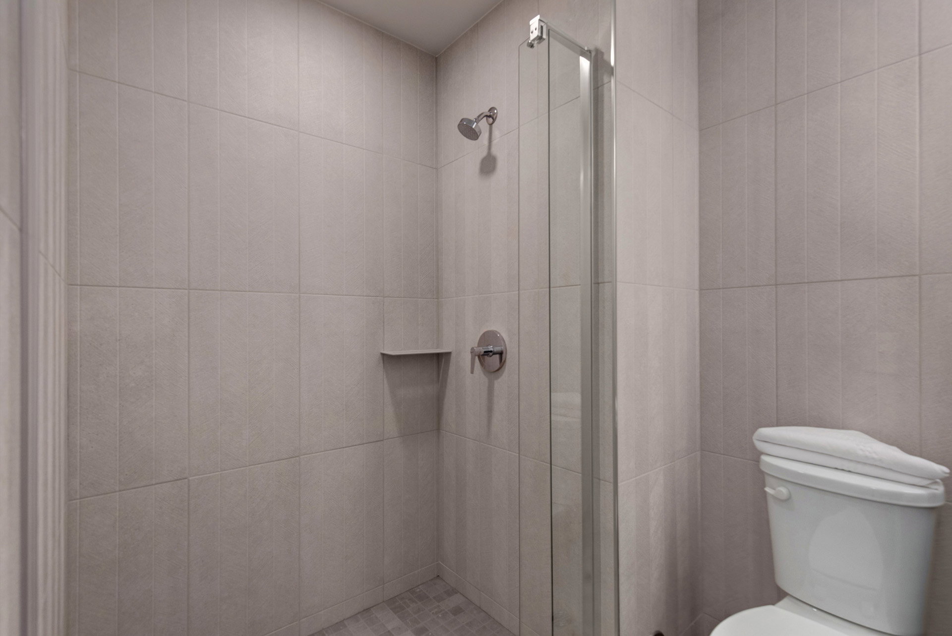 Bathroom featuring a shower stall and toilet