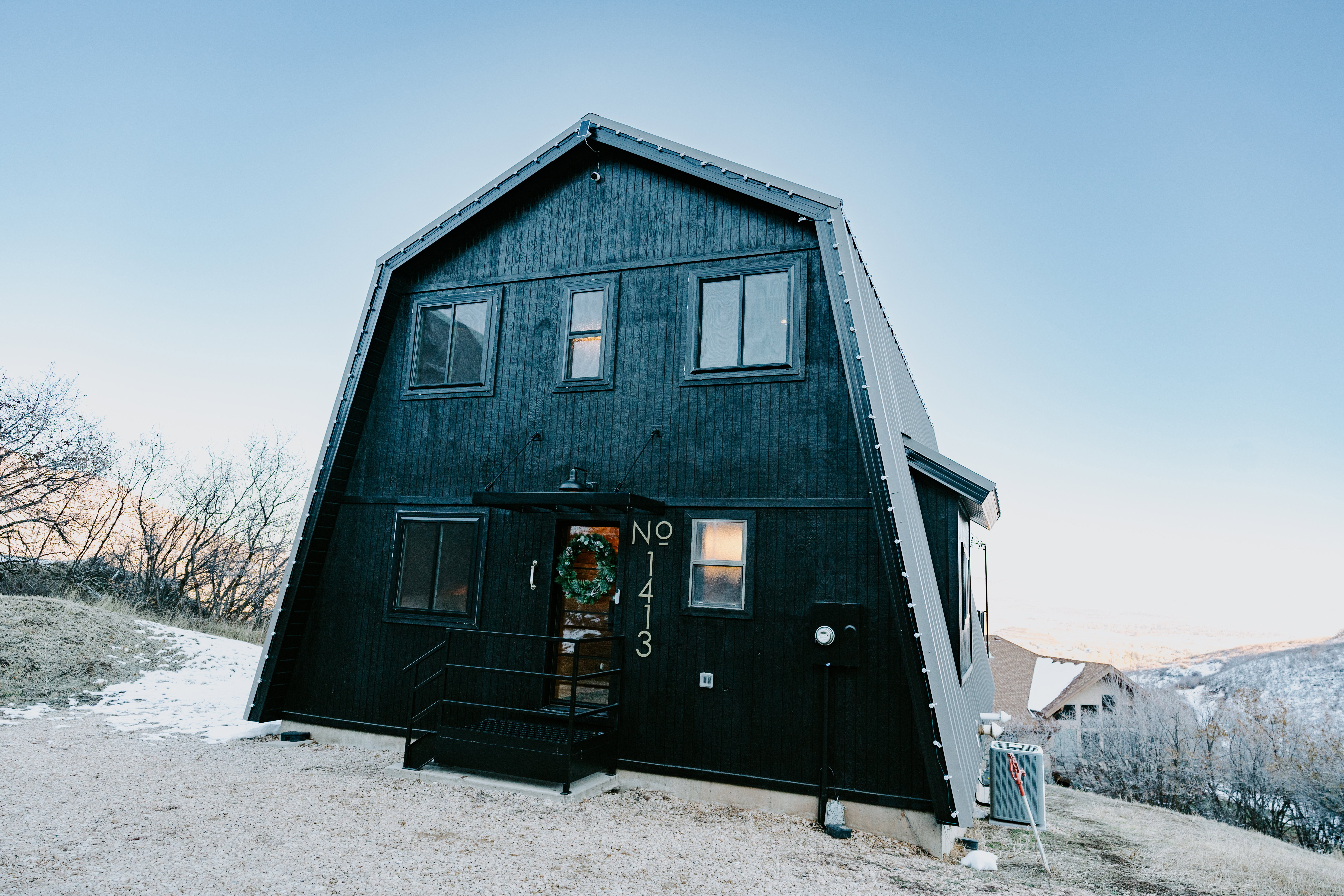 Back of property featuring a gambrel roof