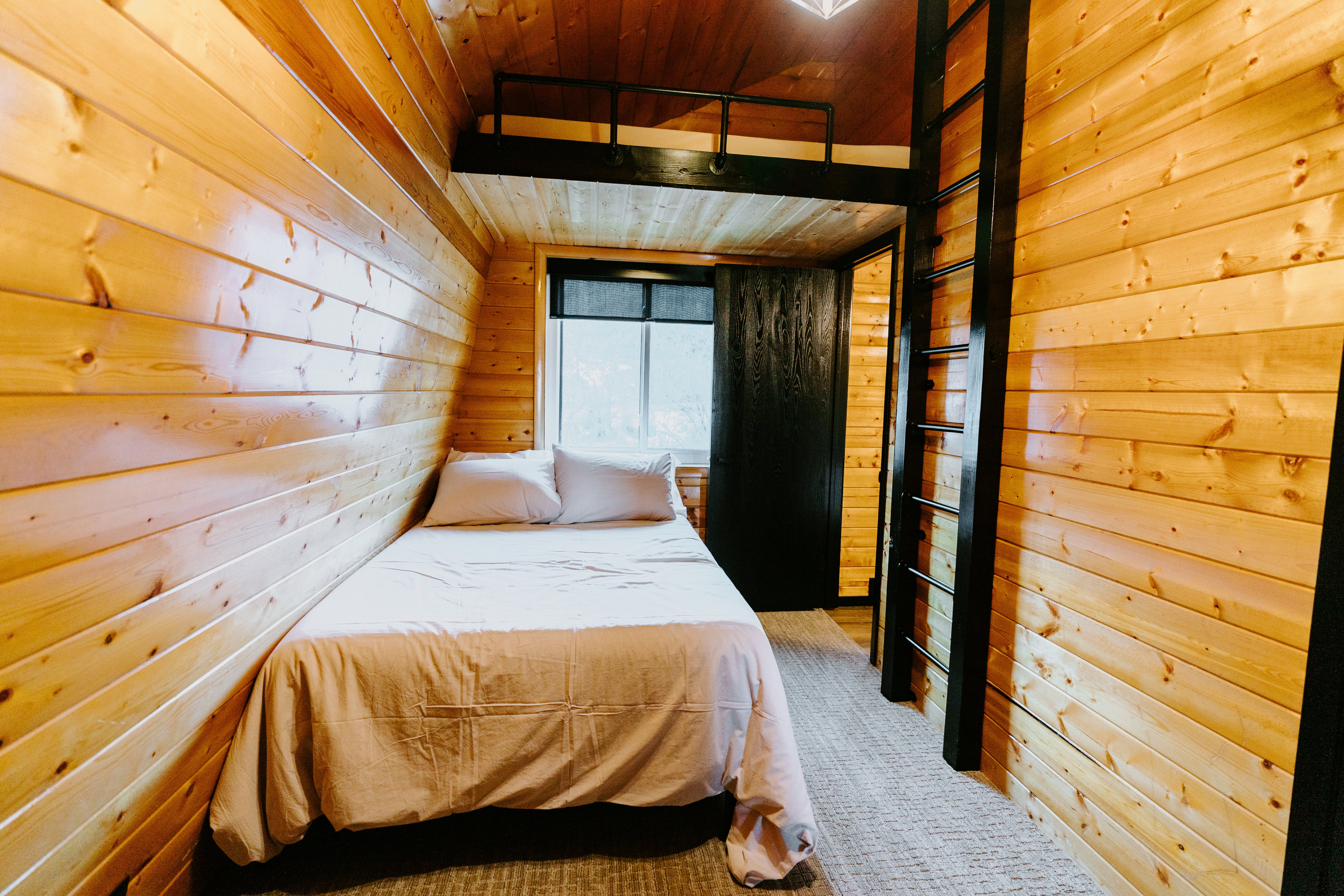 Bedroom with wood ceiling and wooden walls