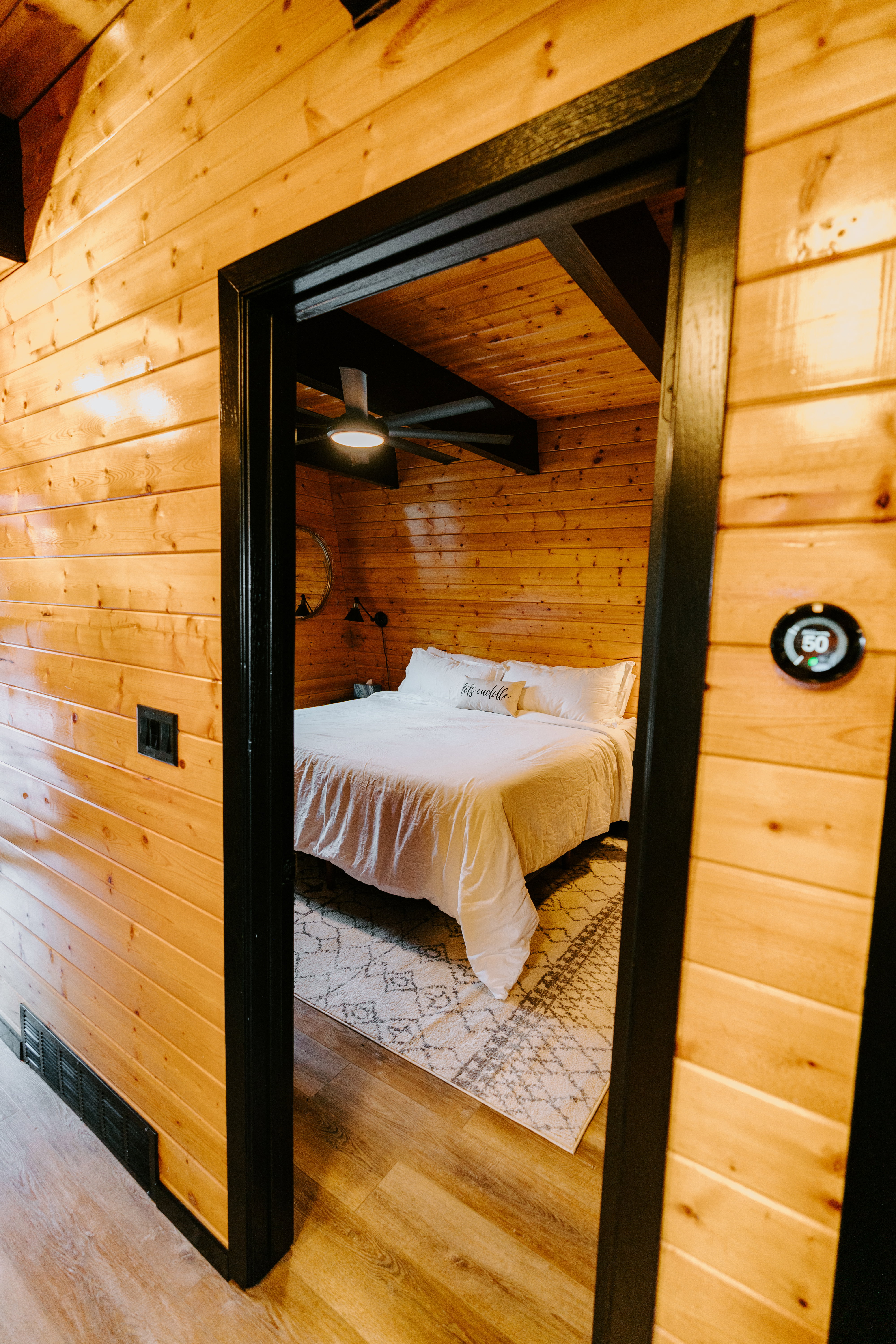 Bedroom featuring wooden walls and wood finished floors