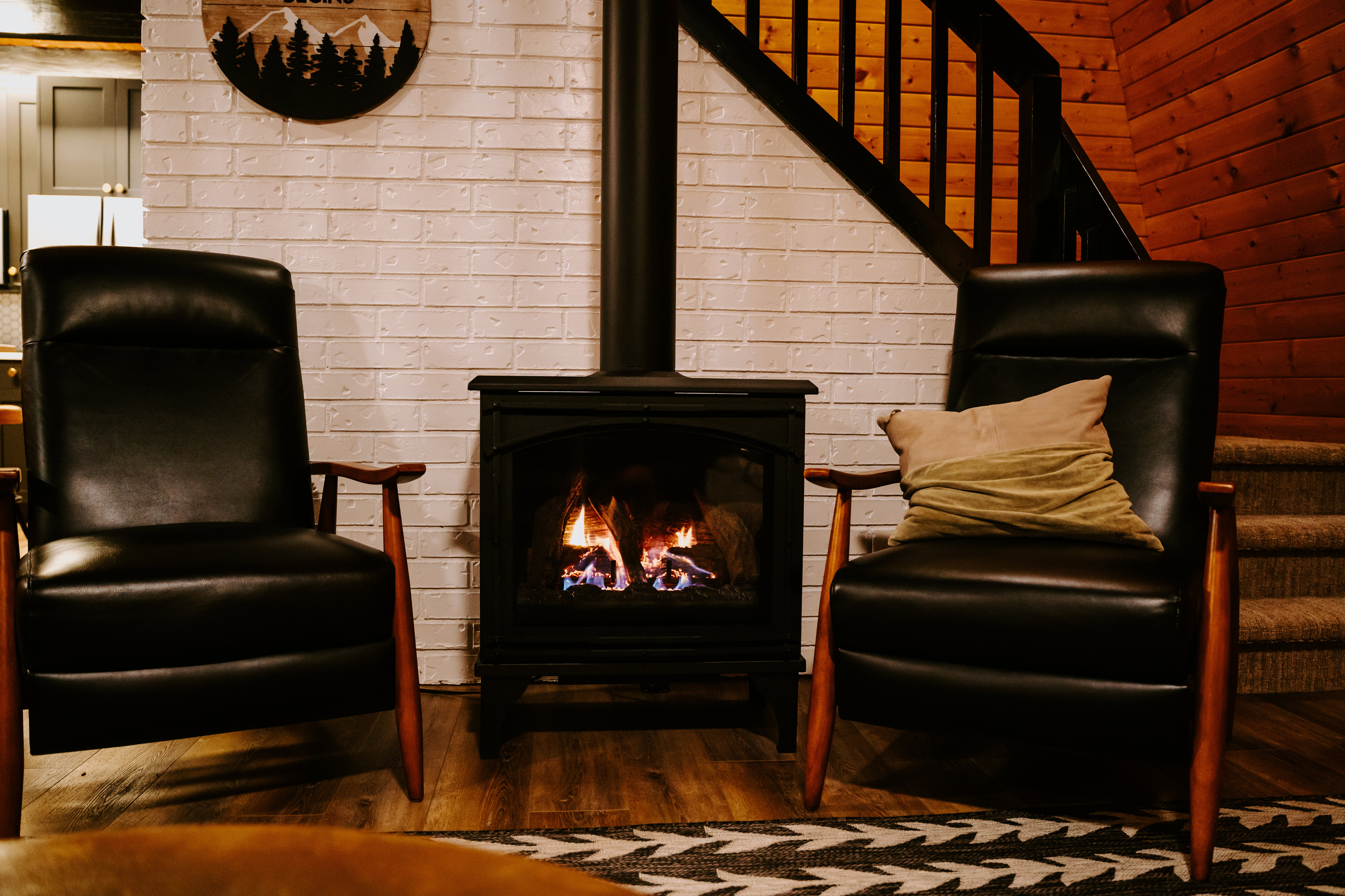 Living area featuring stairway and dark wood-style floors