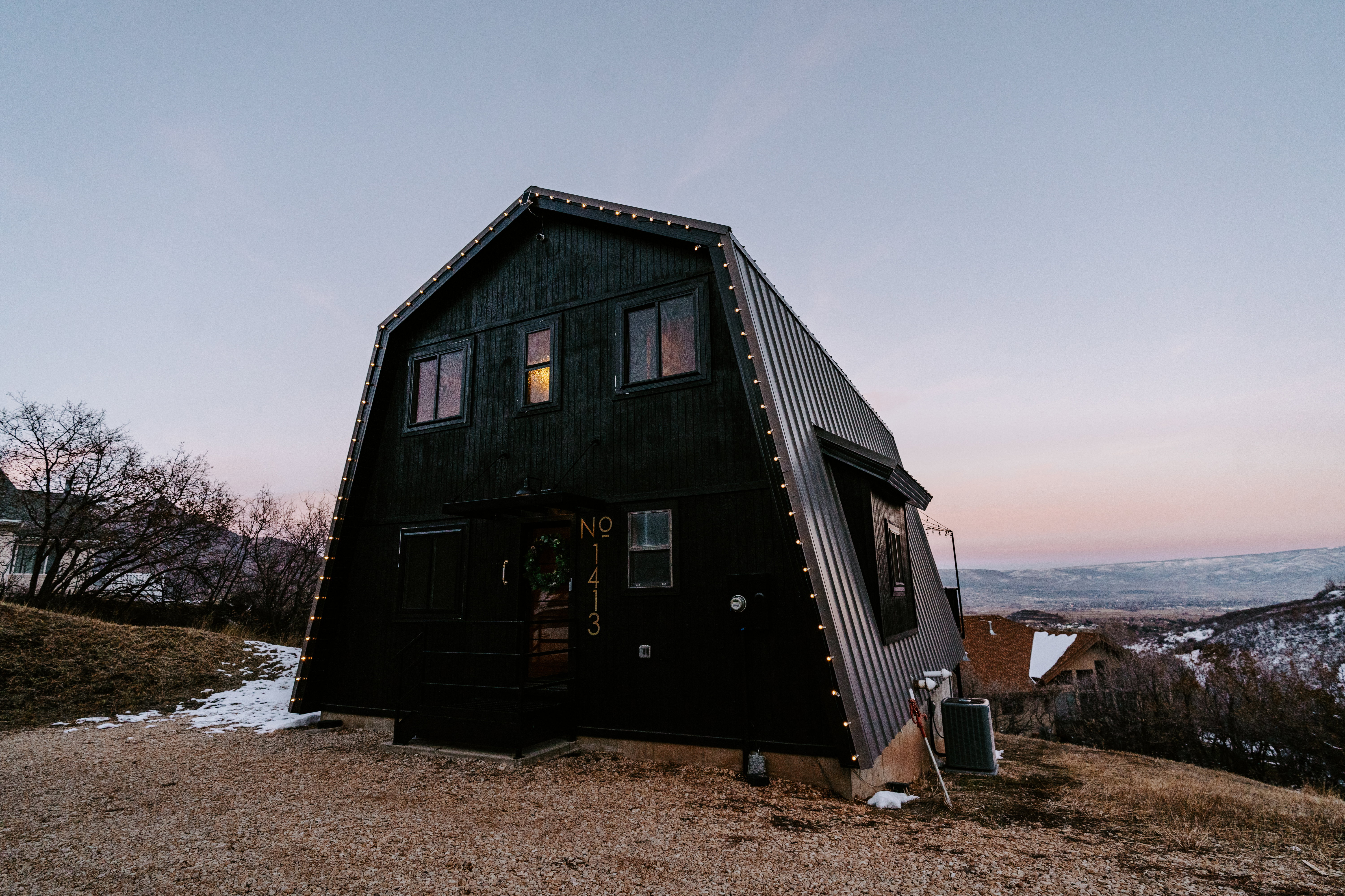 Rear view of property with a gambrel roof