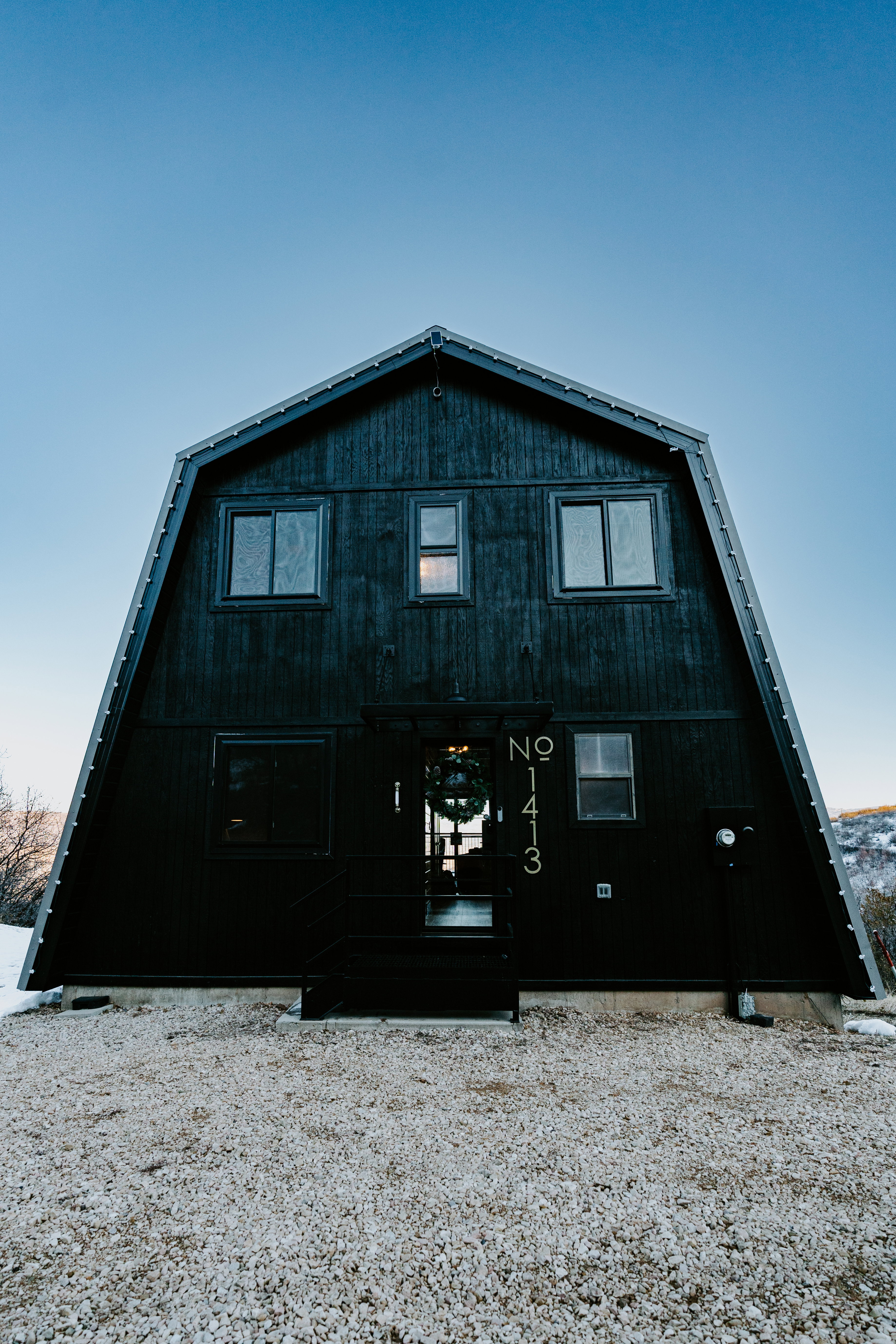Rear view of property featuring a gambrel roof