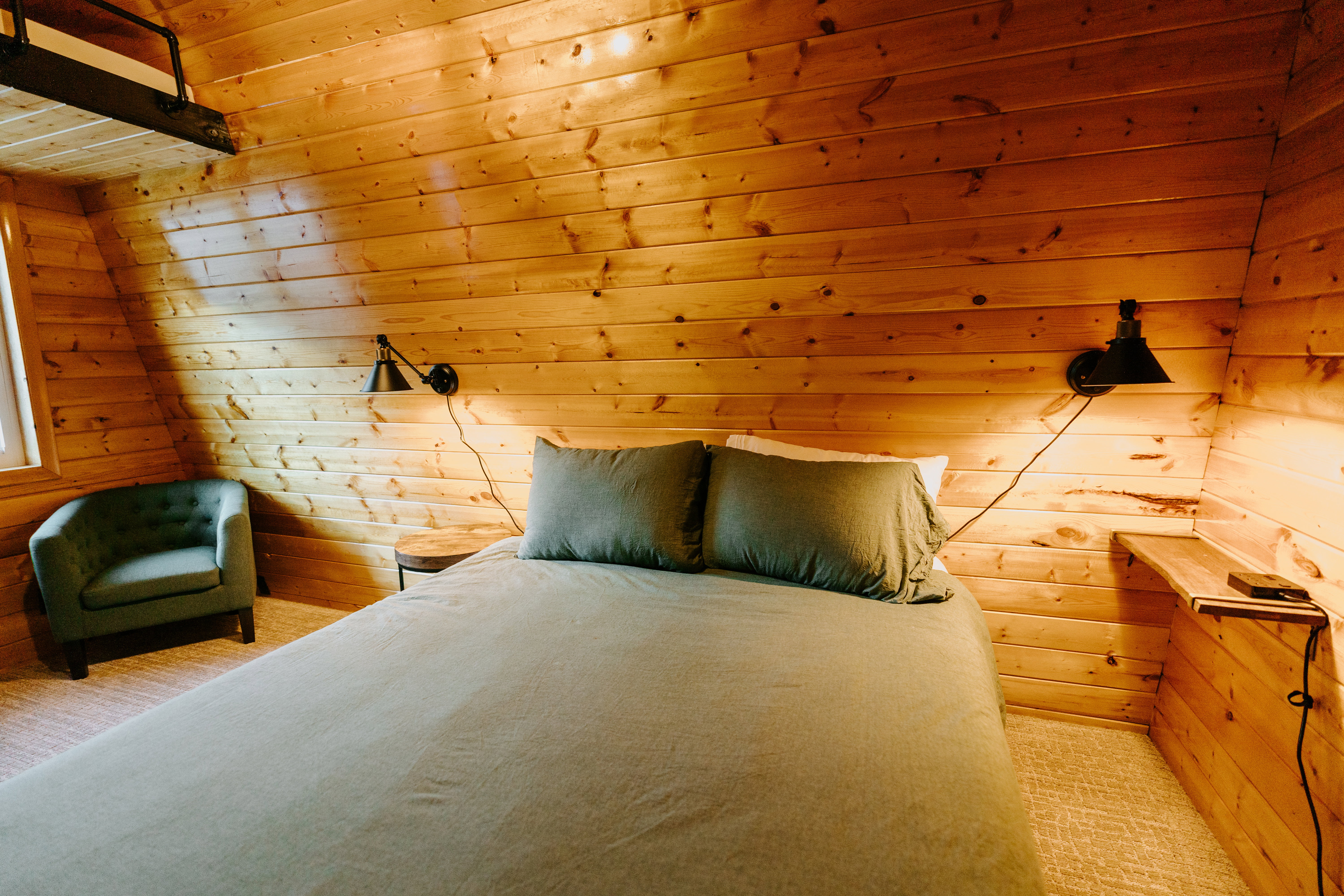 Bedroom featuring wooden walls and wooden ceiling