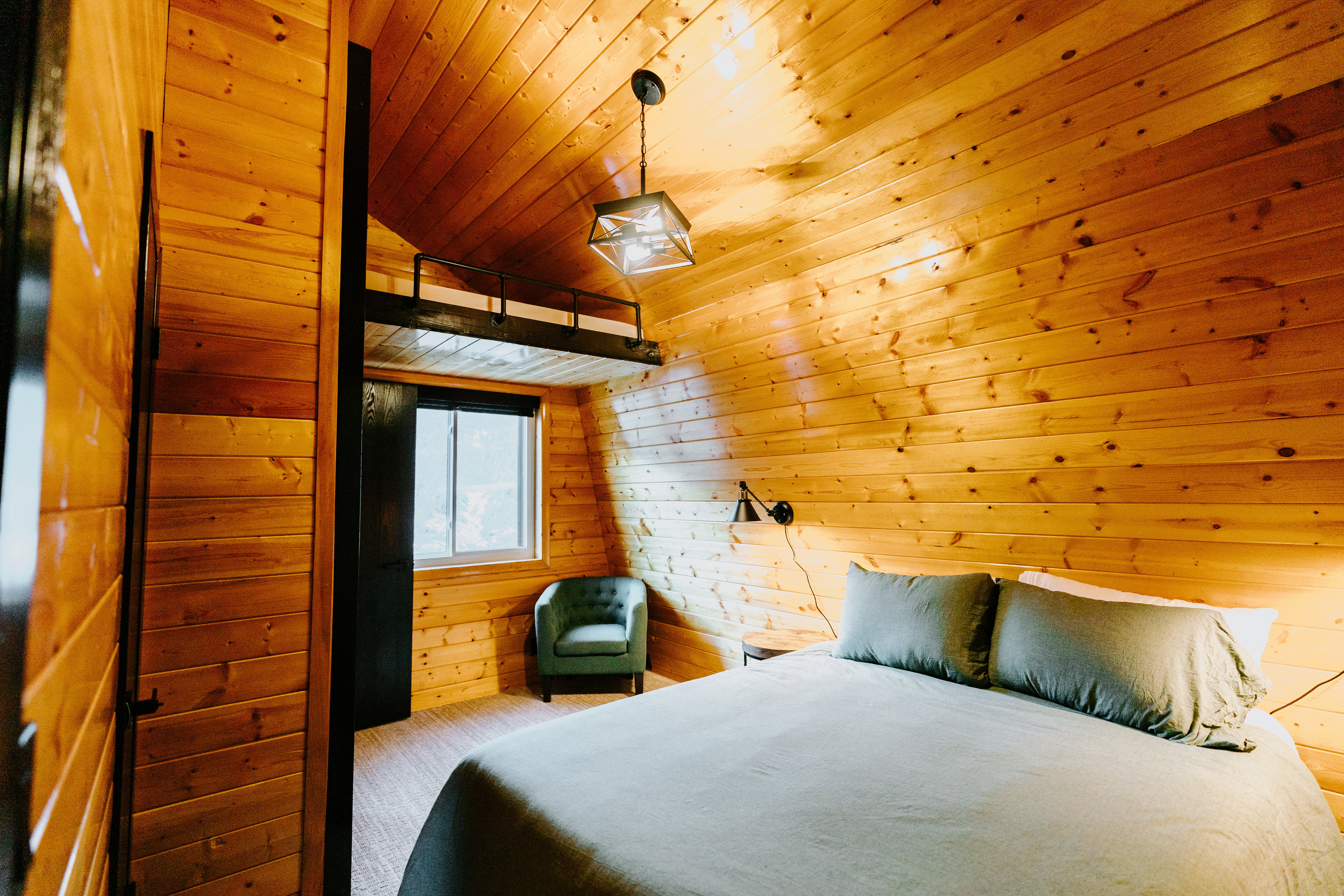 Bedroom featuring wood walls and wooden ceiling