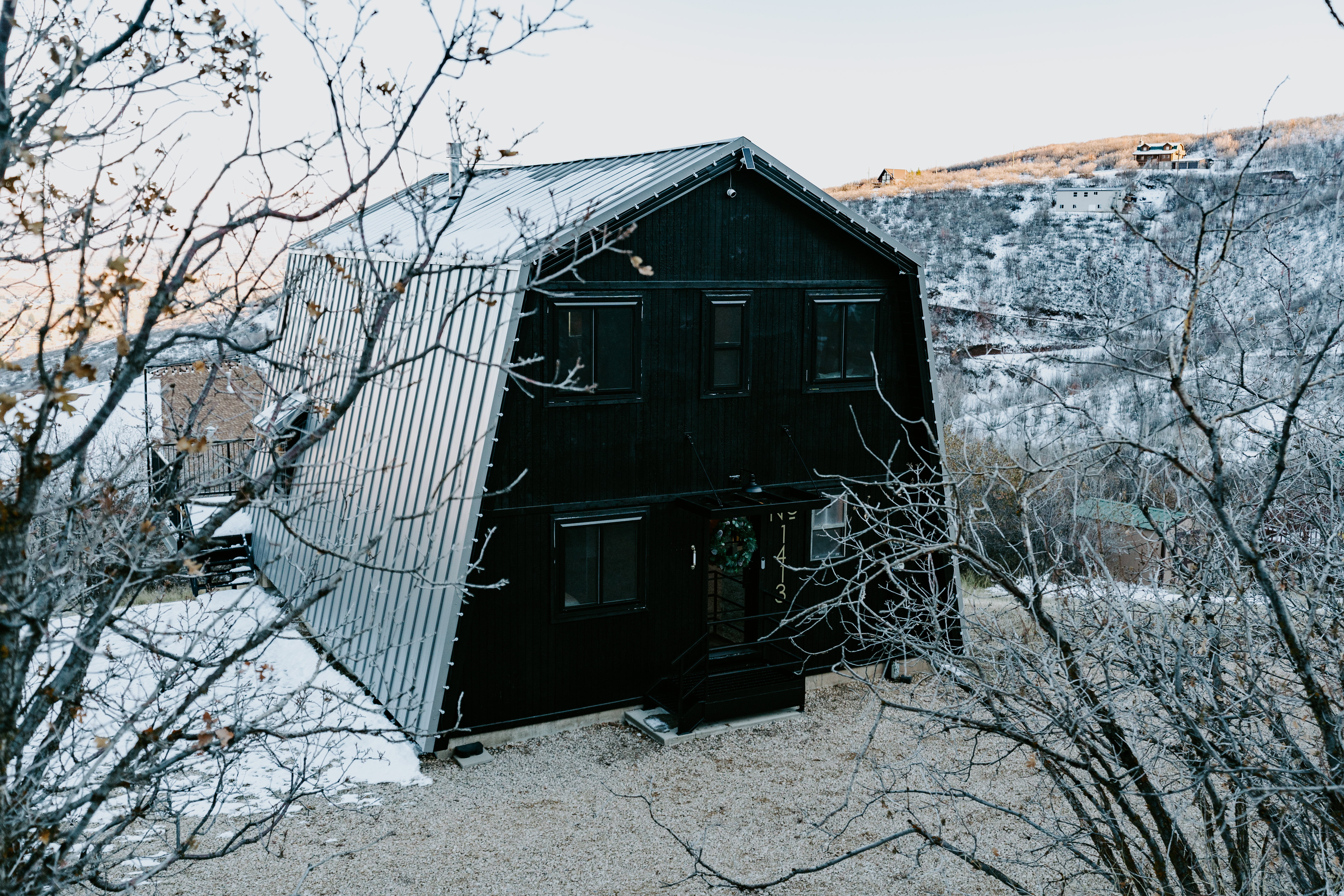 Rear view of house featuring a gambrel roof