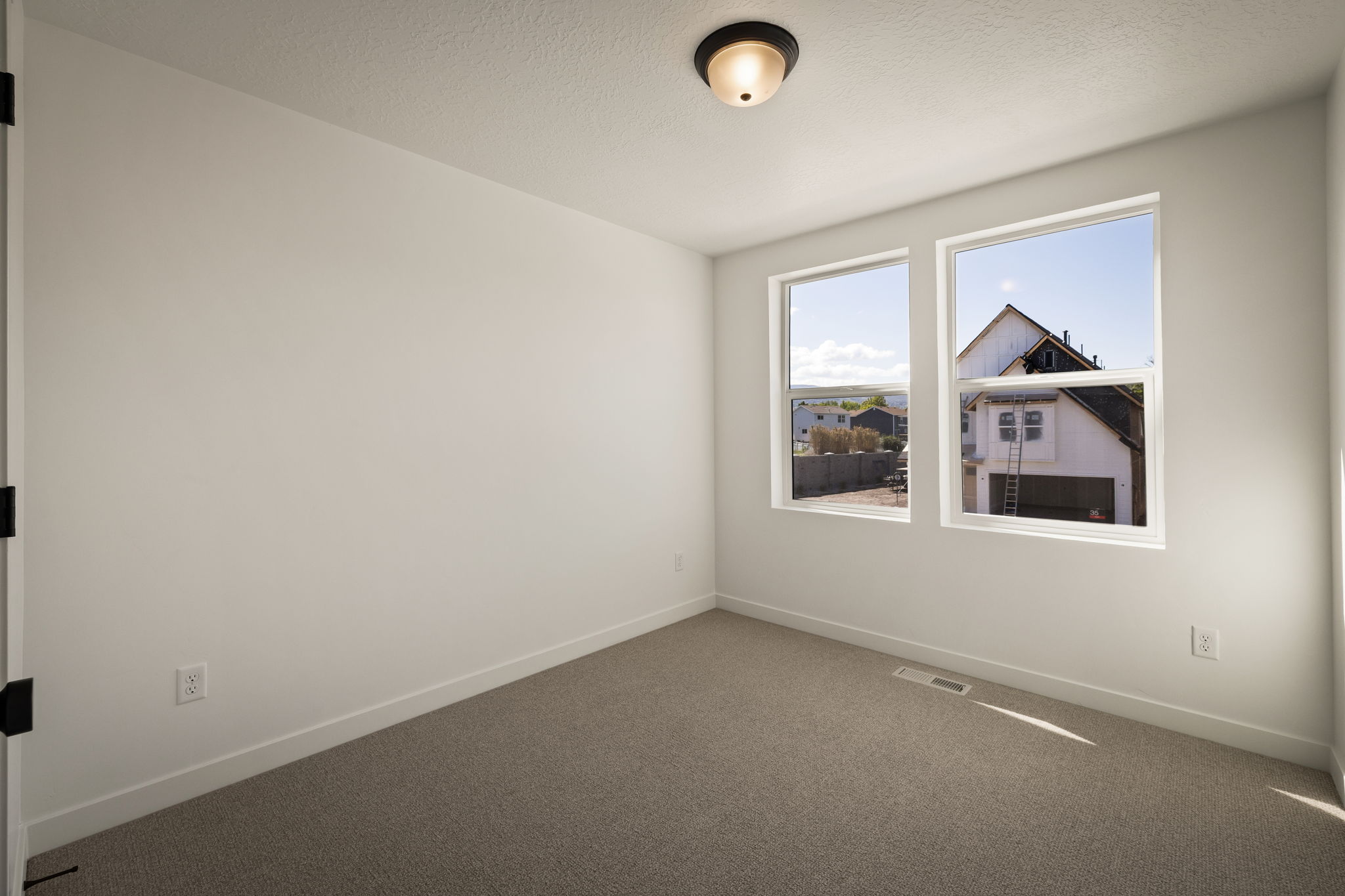 Unfurnished room featuring dark carpet and a textured ceiling