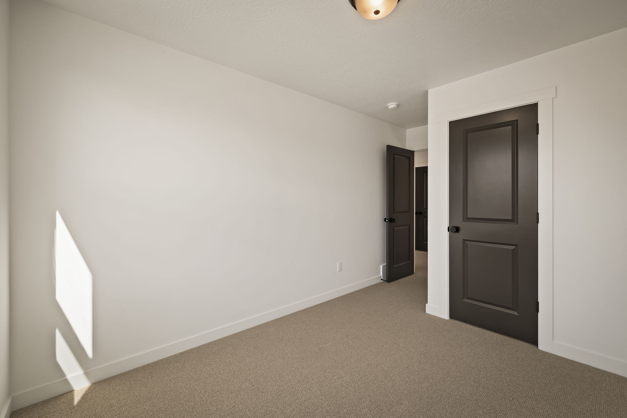 Unfurnished bedroom featuring carpet floors and baseboards