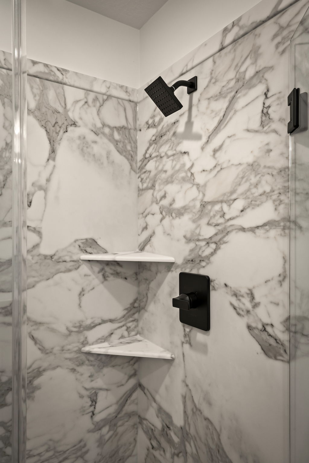 Full bath featuring a marble finish shower
