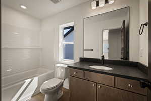 Bathroom featuring vanity, washtub / shower combination, and recessed lighting