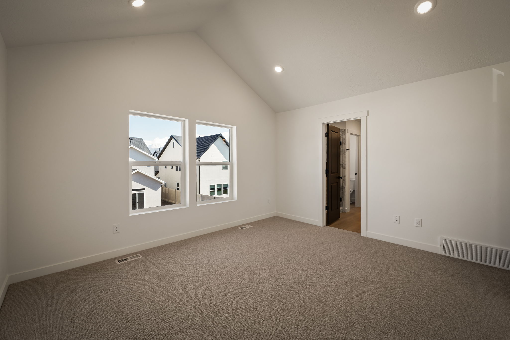 Additional living space with carpet, recessed lighting, and a high ceiling