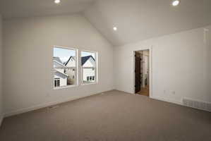 Additional living space with carpet, recessed lighting, and a high ceiling