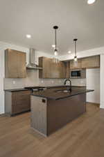 Kitchen with a kitchen island with sink, hanging light fixtures, dark wood finished floors, and dark stone counters