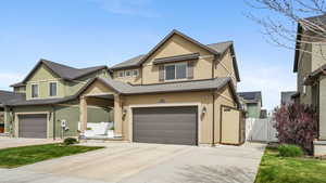 View of front of property with a gate, stucco siding, a garage, concrete driveway w/RV Parking where the shed is sitting.