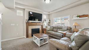 Living room featuring a tile fireplace and carpet flooring