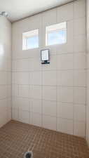 Master bathroom featuring walk in tiled shower