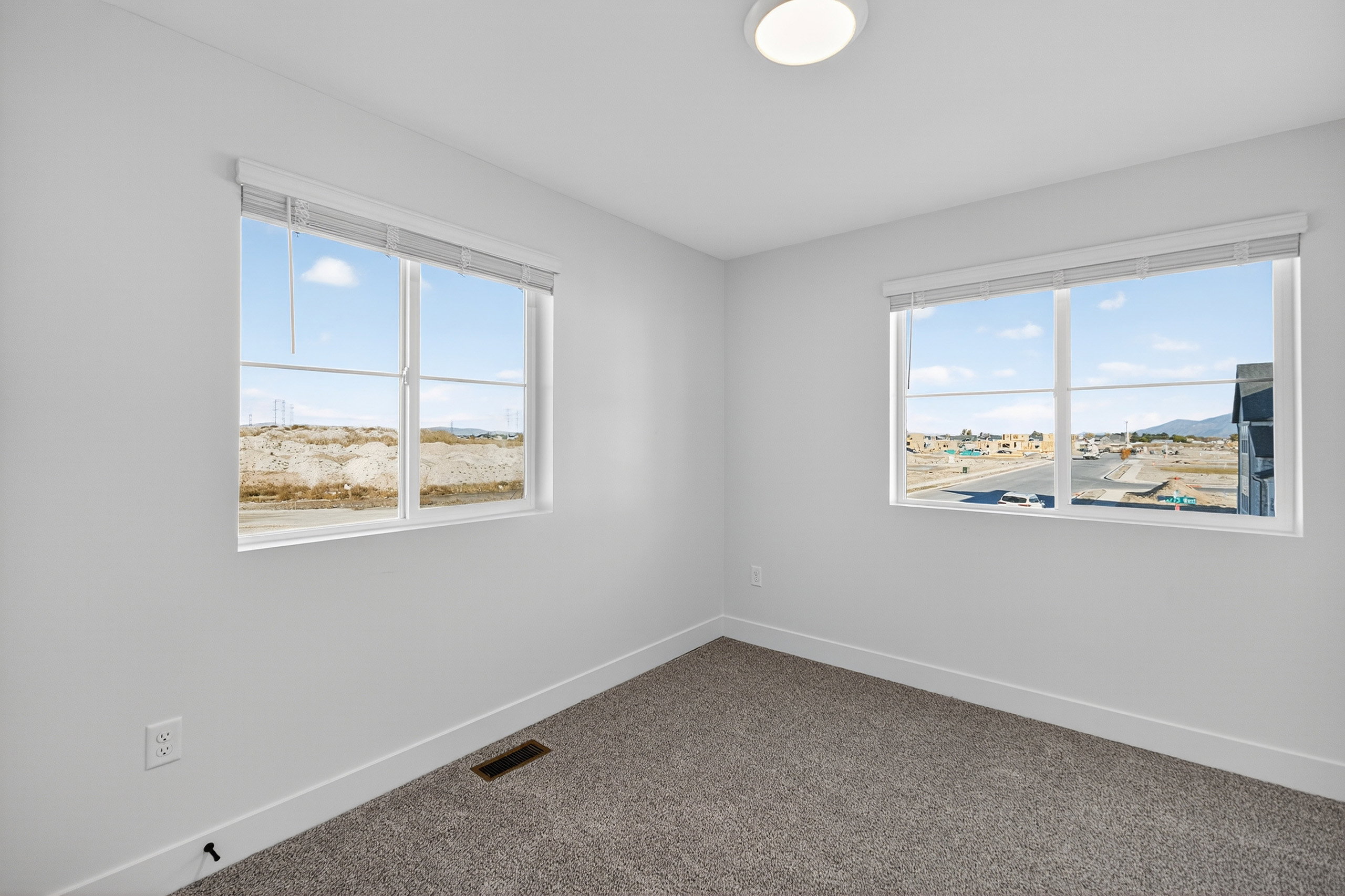 Spare room with dark colored carpet and healthy amount of natural light
