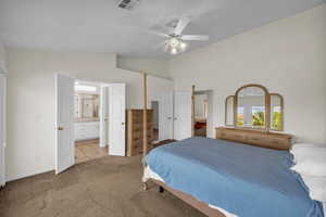 Bedroom featuring connected bathroom, lofted ceiling, carpet floors, and ceiling fan