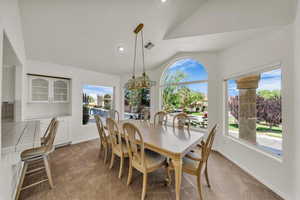 Dining room featuring vaulted ceiling, carpet, and recessed lighting
