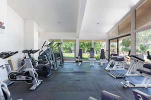 Exercise room with lofted ceiling with beams