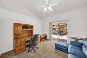 Office area with lofted ceiling, ceiling fan, and carpet floors