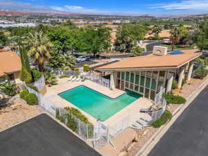 Community pool with a patio area and a mountain view