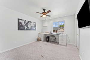 Home office featuring light carpet, a ceiling fan, and recessed lighting