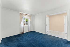 Spare room with light carpet and ornamental molding