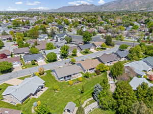 Aerial view of property's location with nearby suburban area and a mountainous background