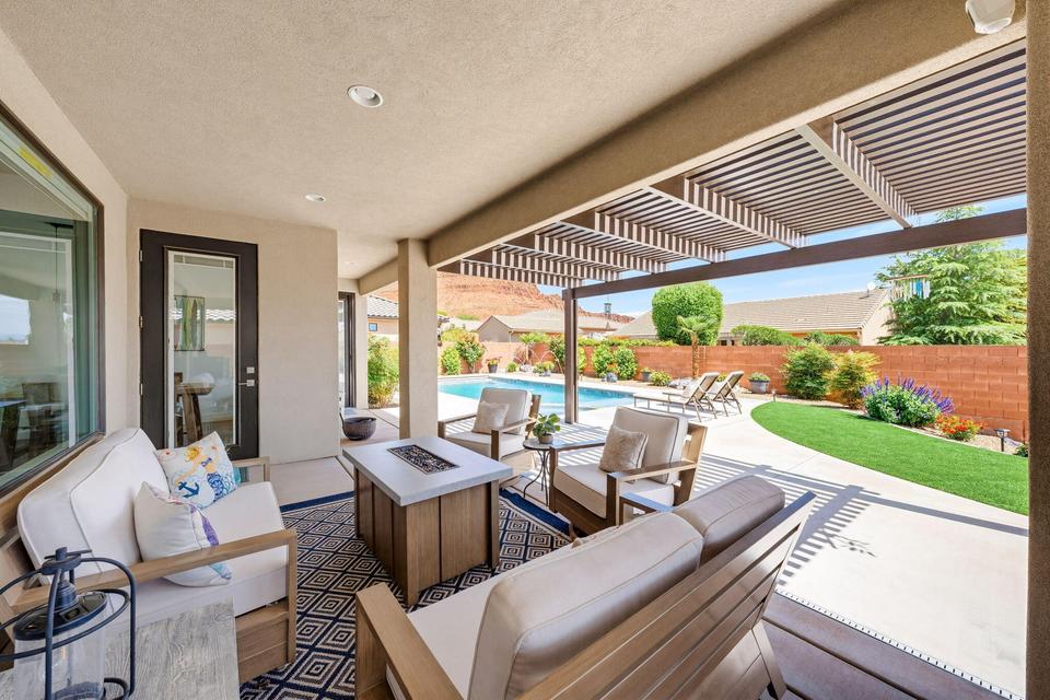 Fenced backyard with an outdoor living space with a fire pit, a pergola, and a patio
