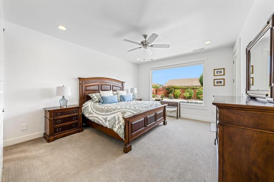 Bedroom featuring light colored carpet, ceiling fan, and recessed lighting