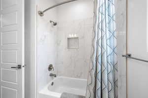 Full bath with shower / tub combo with curtain